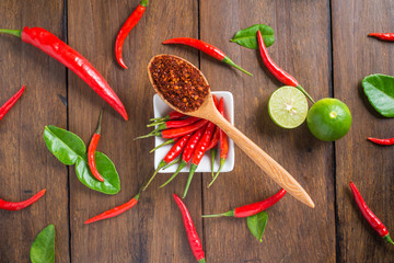 Chili, garlic and lime on wooden background