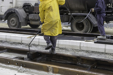 Wall Mural - Workers sprays bitumen emulsion onto the road 2