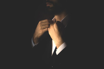 Wall Mural - A man in a business suit straightens his shirt