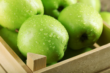 Ripe green apple in crate close up