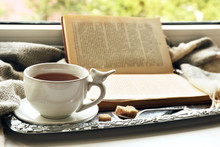 Cup Of Tea With Book On Metal Tray, Closeup