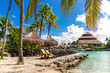 Relax in Mexico. Tropical paradise beach with sun beds under the palm trees in Xcaret park