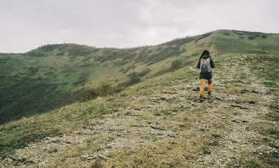 Sticker - Hiker woman goes up in the mountain