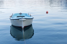 Small Blue Fishing Boat In Calm Water