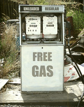 Aged And Worn Vintage Photo Of Retro Gas Pump Offering Free Gas