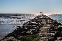View Of The Jetty At The Virginia Beach Oceanfront Extending To The Horizon Line.  