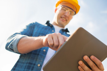 Wall Mural - close up of builder in hardhat with tablet pc