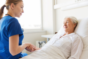 Wall Mural - doctor or nurse visiting senior woman at hospital