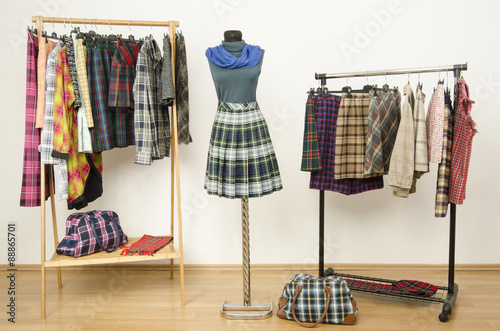 Dressing Closet With Plaid Clothes Arranged On Hangers And An