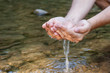 canvas print picture - Human hands splashing pure water from river