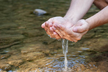 Human Hands Splashing Pure Water From River