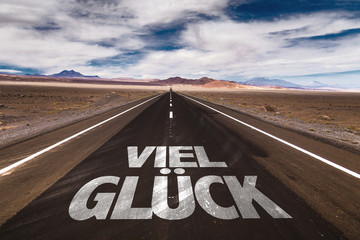 Good Luck (in German) written on desert road