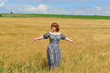woman in maxi dress standing on  rye field