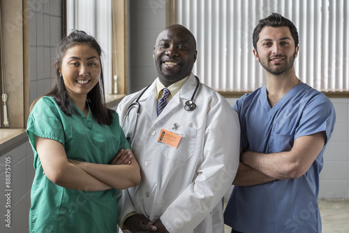 Fotografie, Obraz Portrait of a proud Asian female nurse, Caucasian male nurse, and African Americ