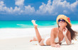 © el.rudakova - beautiful woman with sun hat and flower having fun at beach