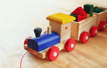 close up of Wooden toy train over wooden table. selective focus.