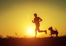 Silhouette Of Runner With Dog  In Sunset Rise
