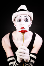 Portrait Of Mime With Red Gerbera Flower