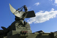 Air Defense Radar Of Military Mobile Mighty Rocket Launcher System Of Green Color, Modern Army Industry, White Cloud And Blue Sky On Background 