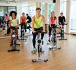 © Nejron Photo - Multiracial group during aerobics class on a bicycles