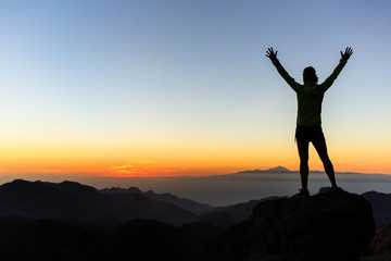 Wall Mural - woman climber success silhouette in mountains, achievement inspi