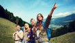© Syda Productions - group of smiling friends with backpacks hiking