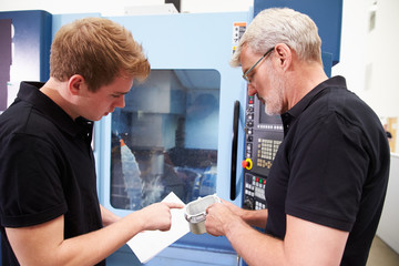 Wall Mural - Male Apprentice Working With Engineer On CNC Machinery