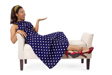Woman In Vintage Blue Poka Dot Dress Relaxing On A Chaise Lounge