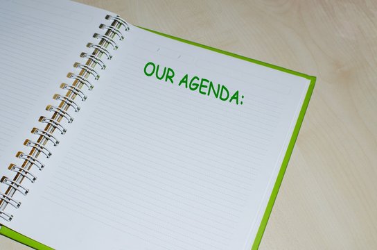 Wall Mural -  - Our agenda written on open notebook over wooden background