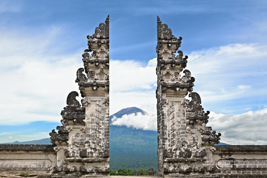 entrance gate pintu bintar to traditional temple lempuyang on agung mount background - bali island s