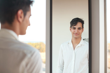 happy young man with mirror