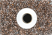 Cup Of Coffee With A Brown Beans Background