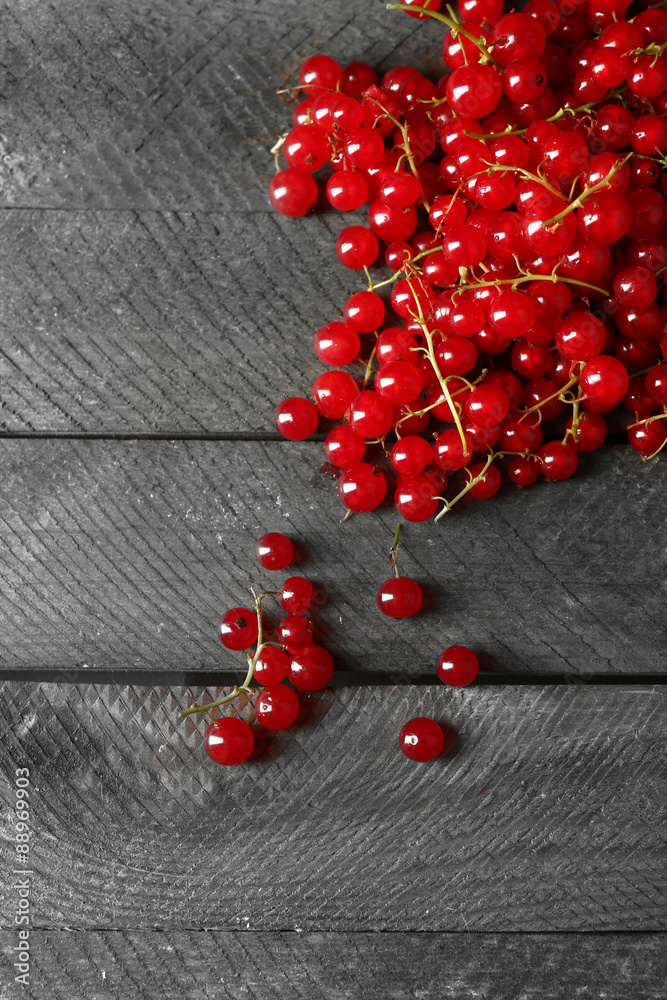Ripe red currant on wooden background