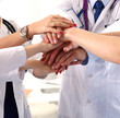 © lenetsnikolai - A group of doctors shaking hands