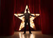 Man on stage with star on background