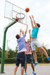 © Syda Productions - group of happy teenage friends playing basketball