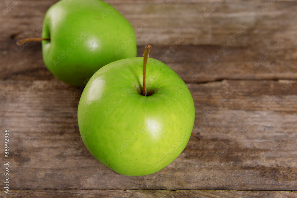 Ripe green apples on wooden table close up