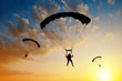 Leinwandbild Motiv Silhouette skydiver parachutist landing