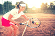 © aboutmomentsimages - beautiful brunette girl playing tennis with racket, balls and sports equipment. Close up portrait of beautiful woman on tennis court with athletic wear and smiling