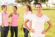 © WavebreakMediaMicro - Smiling brunette wearing pink for breast cancer