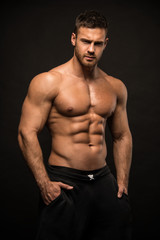 Poster - muscled male model in studio