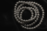 Fototapeta Łazienka - white pearl necklace on a black silk
