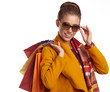 © ZoomTeam - Woman wearing autumn overcoat holding shopping bag.