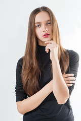 Sticker - Fashion model with long hair in black sweater poses on white