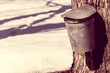 Vintage look covered maple syrup sap bucket with snow