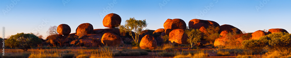 Devil's Marbles, Australia. The Devils Marbles are an extensive collection of red granite boulders in the Tennant Creek area of Australia's Northern Territory - obrazy, fototapety, plakaty 