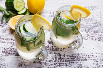 Wall Mural - Lemon and cucumber detox water in glass jars