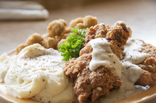 Chicken Fried Steak With Mashed Potatoes And Country Gravy With Fried Okra.