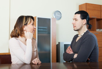 Wall Mural - Serious couple talking at home