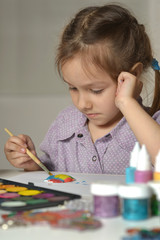 Wall Mural - cute little girl drawing at home